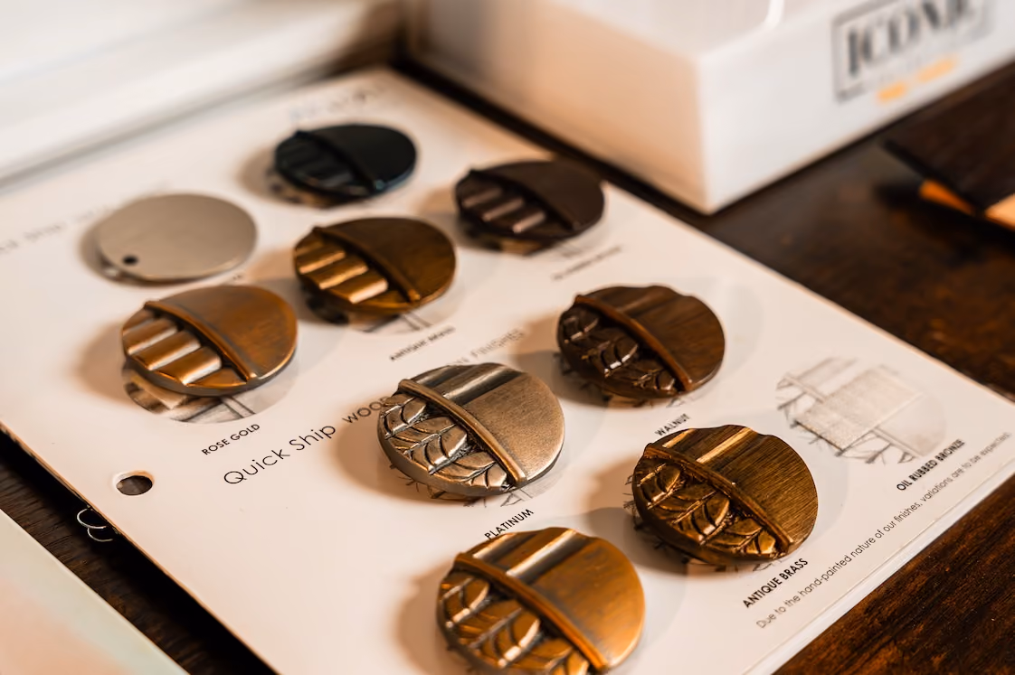 Drapery hardware finish samples labeled rose gold, platinum, antique brass and walnut