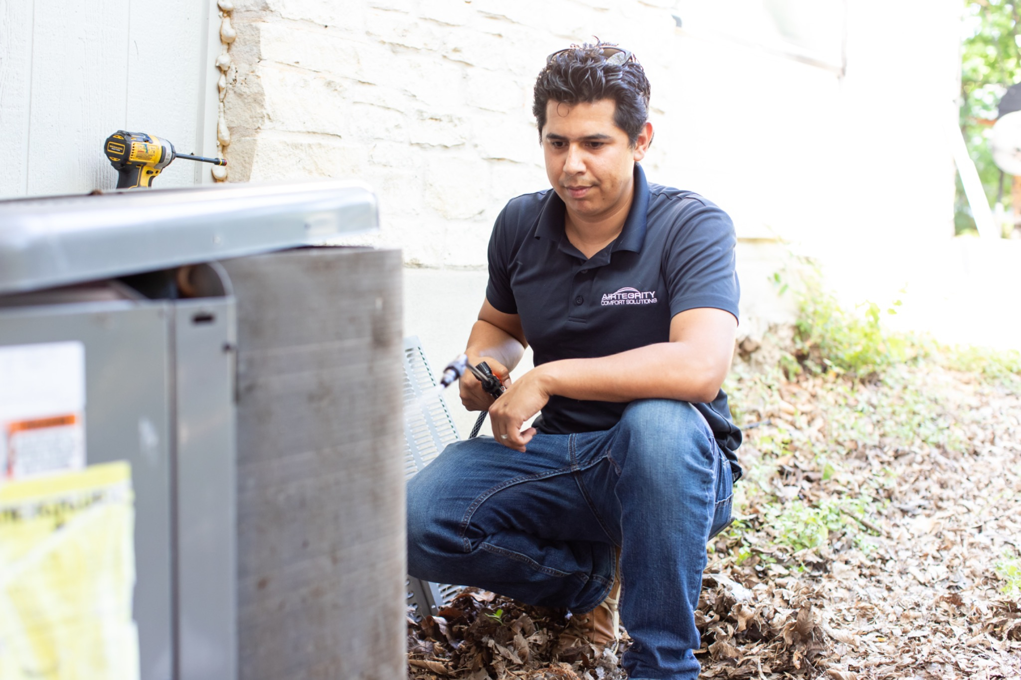 ac technician performing ac maintenance on a ac system