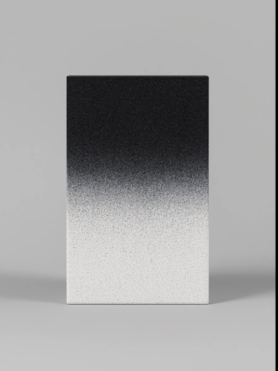Rectangular object with a speckled gradient from black at the top to white at the bottom on a gray background.