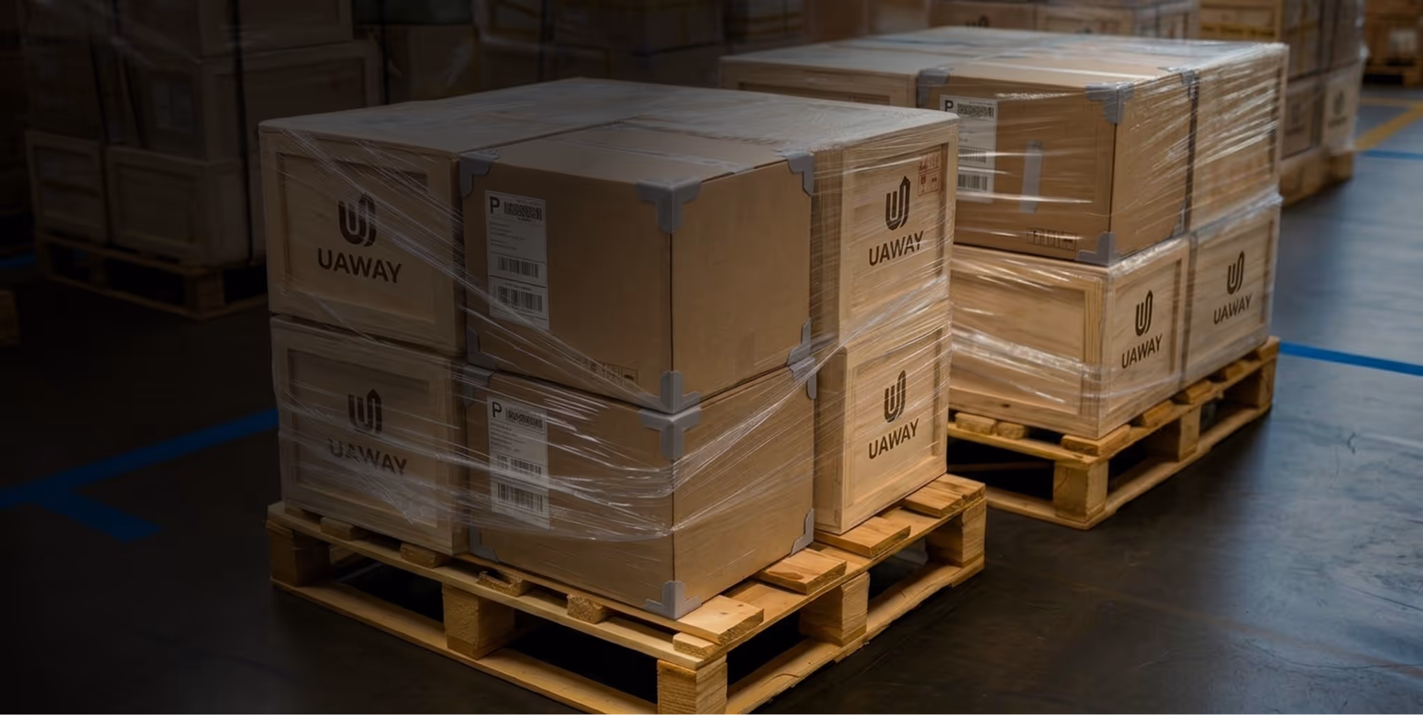 Stacks of sealed cardboard boxes labeled UAWAY wrapped in plastic on wooden pallets inside a warehouse.