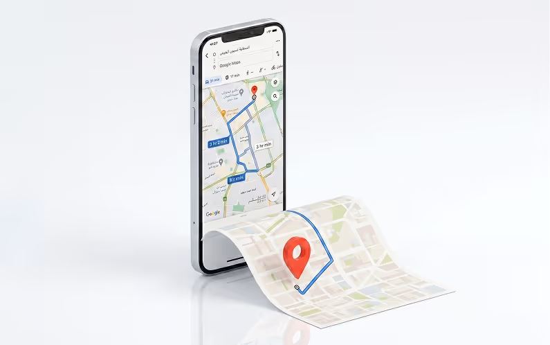 Smartphone displaying a map with a blue route line extending onto a physical paper map with a red location pin.