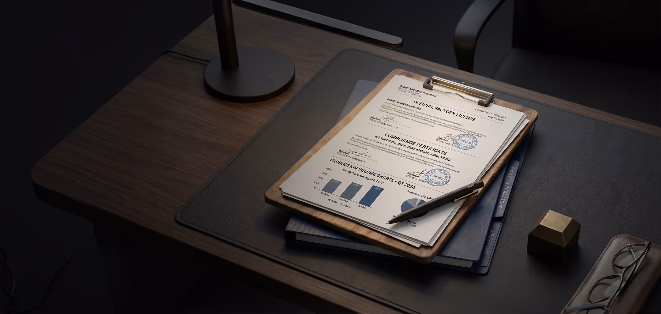 Clipboard with official factory license and compliance certificate showing production volume charts, placed on a dark desk with a pen, folders, a geometric brass object, and eyeglasses.