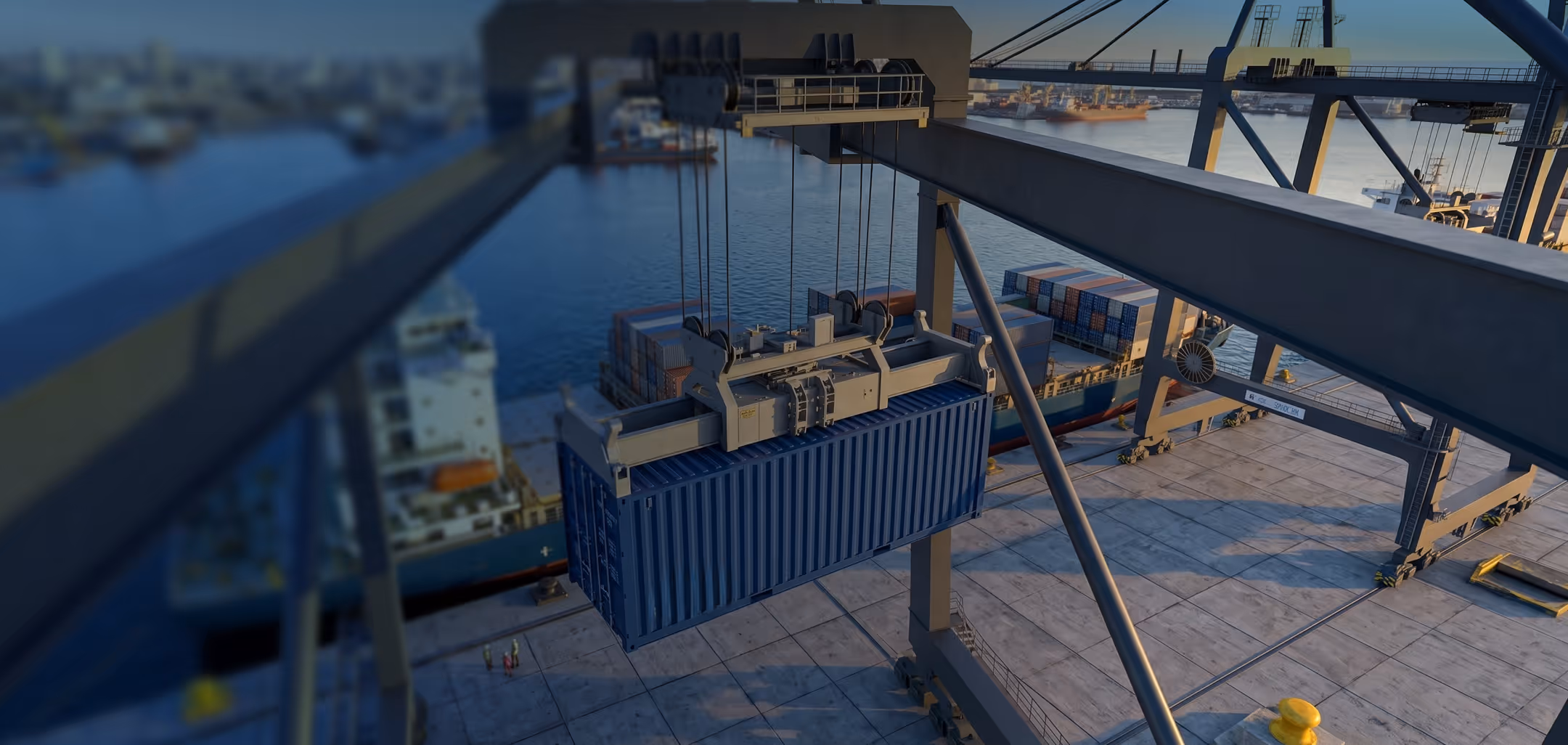 A large blue shipping container being lifted by a crane at a port with container ships and other containers in the background.