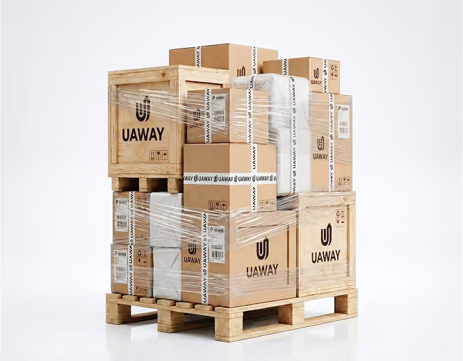 Wooden pallet stacked with various cardboard boxes and crates wrapped in clear plastic labeled UAWAY.
