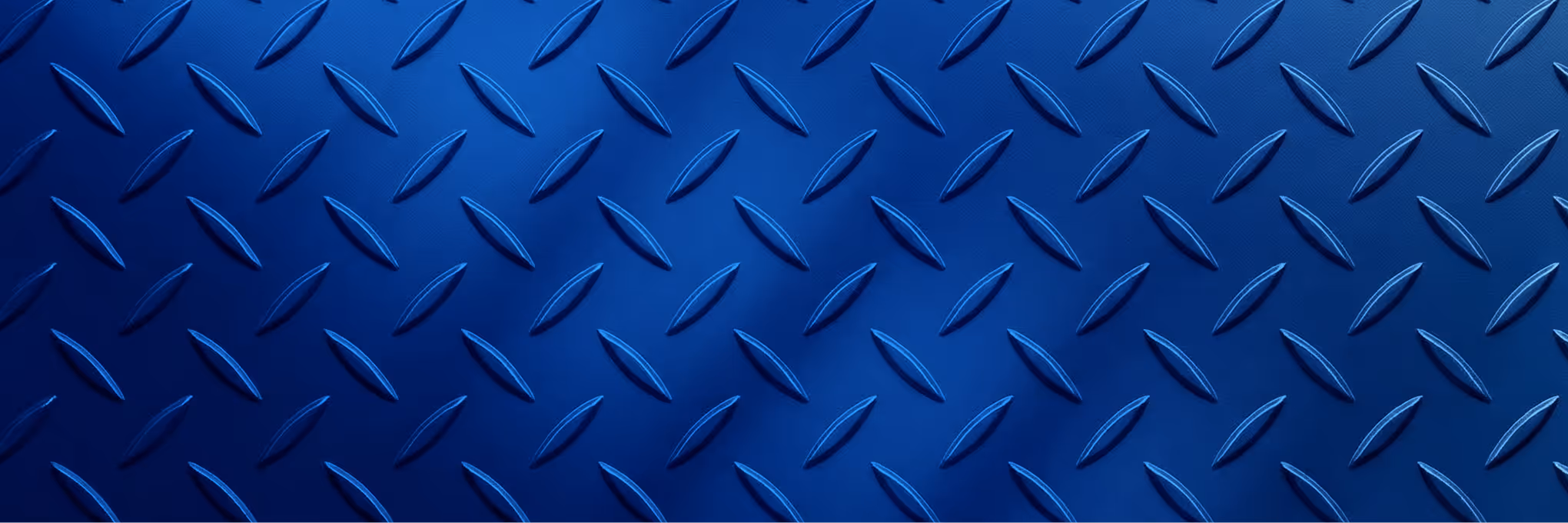 Close-up of blue diamond plate metal texture with raised, elongated diamond-shaped patterns.