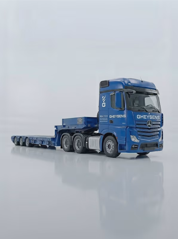 Blue GHEYSENS Mercedes-Benz heavy-duty truck with multi-axle flatbed trailer on a reflective surface.