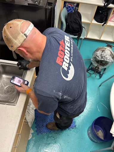 Kitchen plumbing services in Charleston, SC - plumber installing or repairing under-sink plumbing