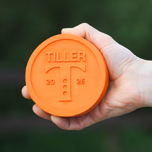 Tiller award held by a hand
