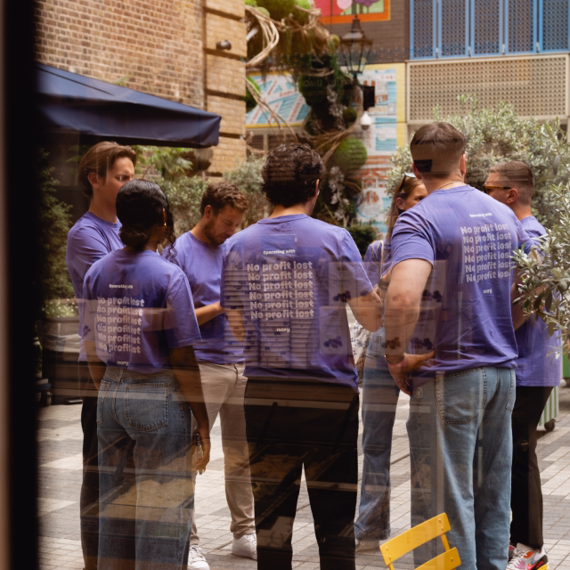 Team members wearing branded Nory t-shirts at a company event