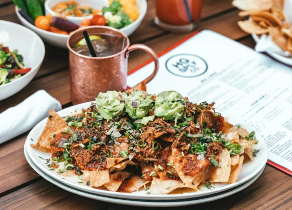 Plate of nachos and a drink in a restaurant