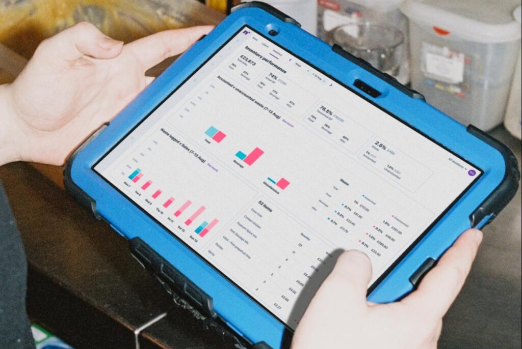 Restaurant worker using Nory's inventory dashboard on a tablet