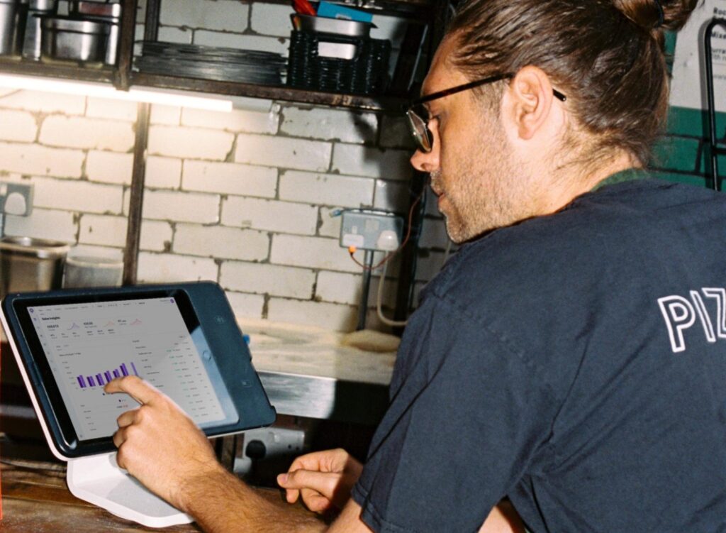 Restaurant employee using Nory on a tablet