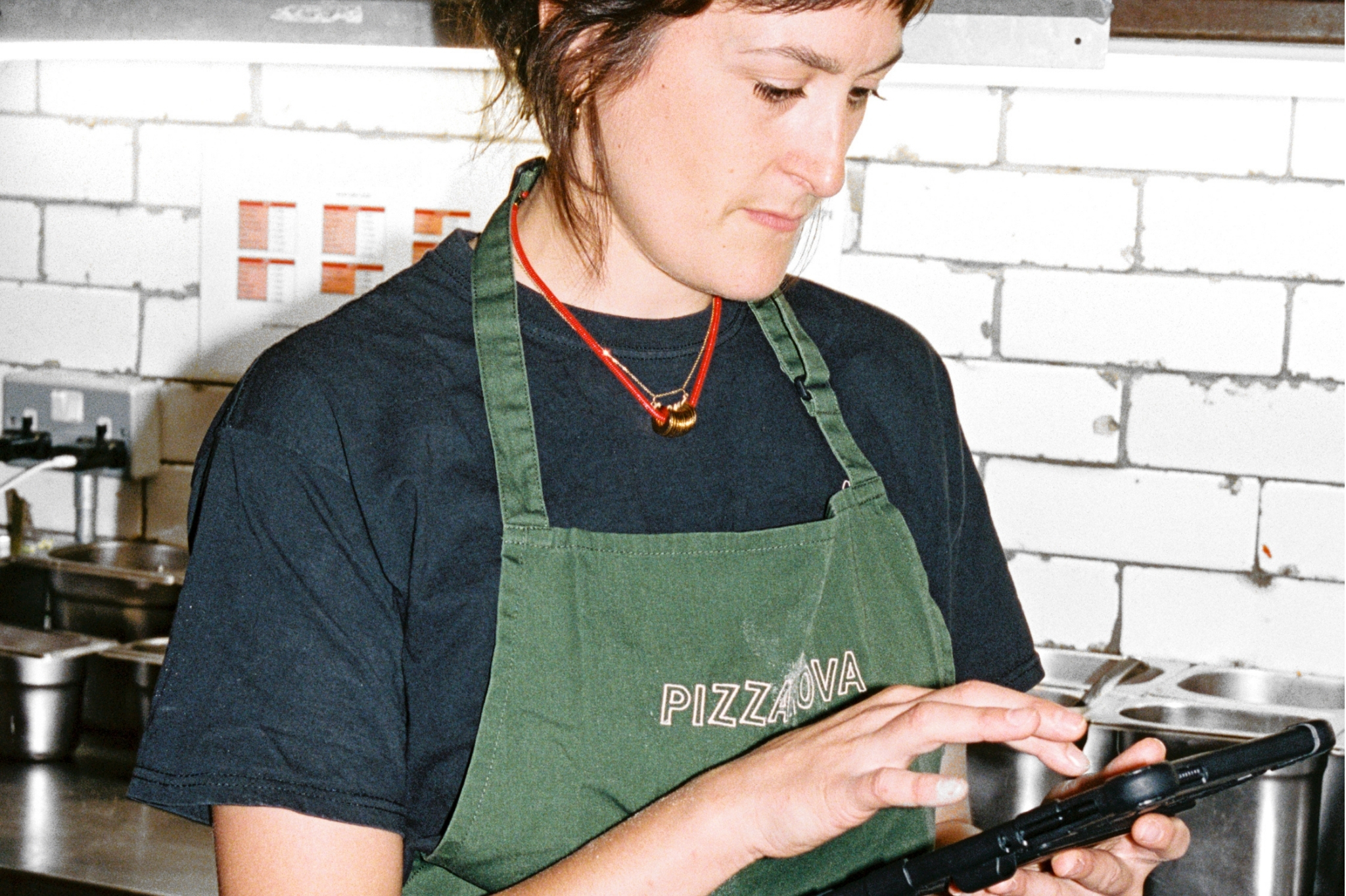 Restaurant employee using Nory for real-time sales and inventory insights