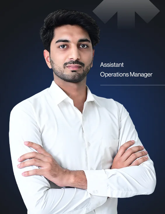 Portrait of a confident man in a white shirt standing with arms crossed against a dark background with the text 'Assistant Operations Manager'.