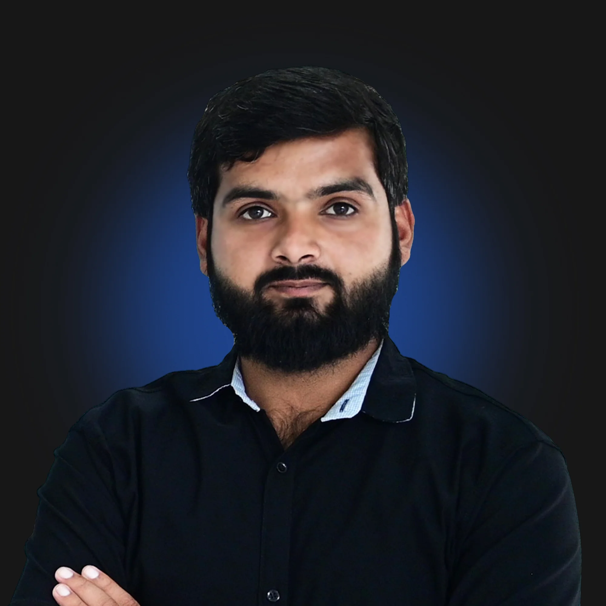Man with beard wearing a black shirt, arms crossed, posing against a dark gradient background.