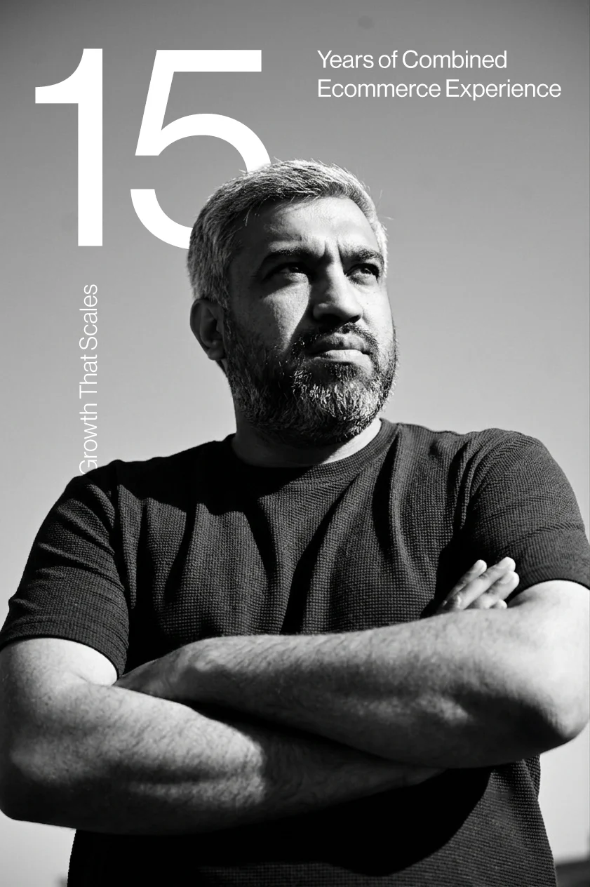 Smiling man with gray hair and beard wearing a white shirt, with text stating 15 years of combined ecommerce experience on a dark blue background.