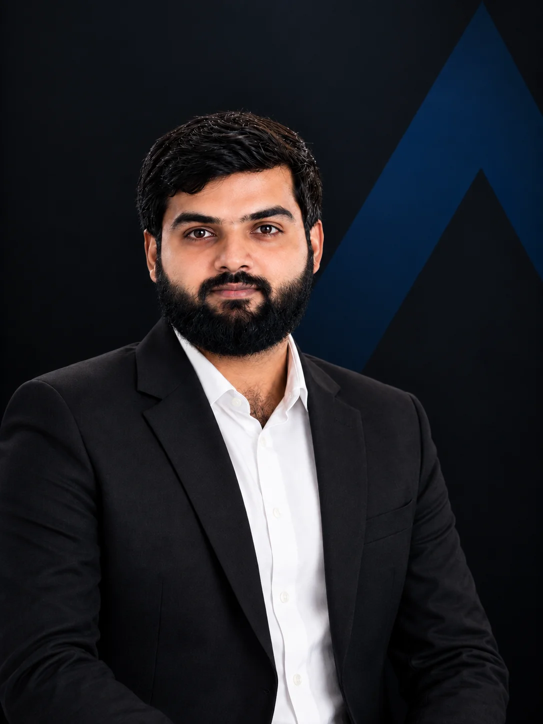 Portrait of a confident man in a white shirt standing with arms crossed against a dark background with the text 'Assistant Operations Manager'.
