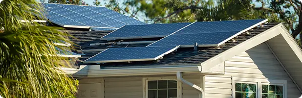Cropped view of a house with solar panels on the roof