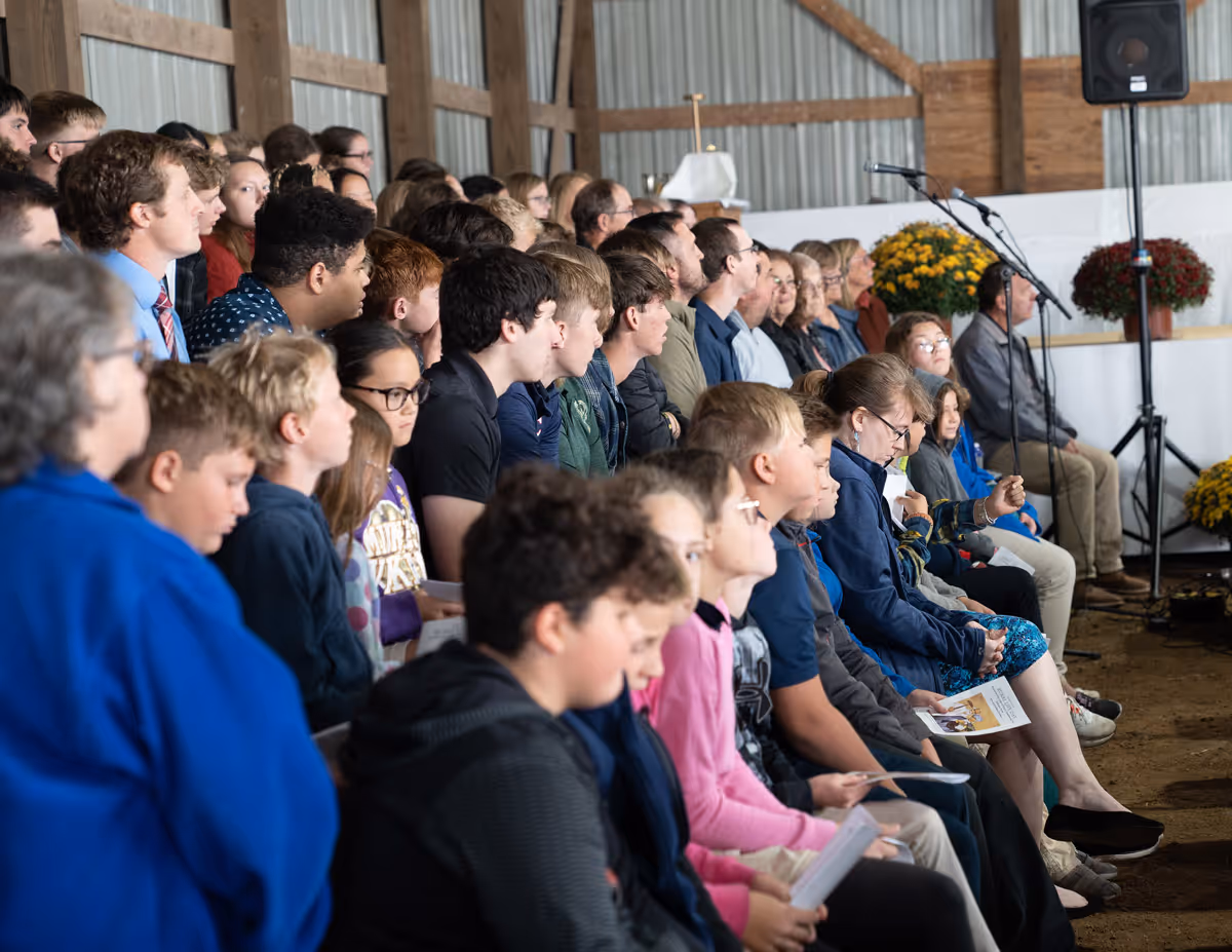 Community of people in at a barn Mass