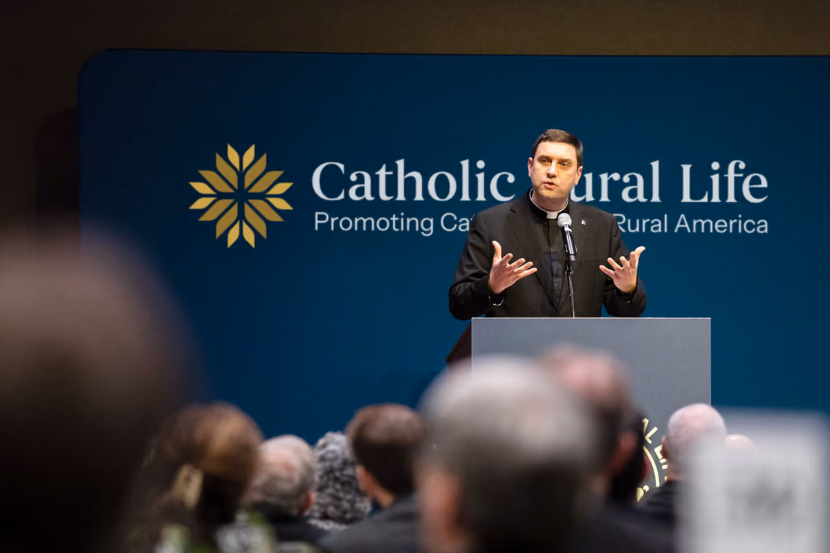 Priest speaking at podium