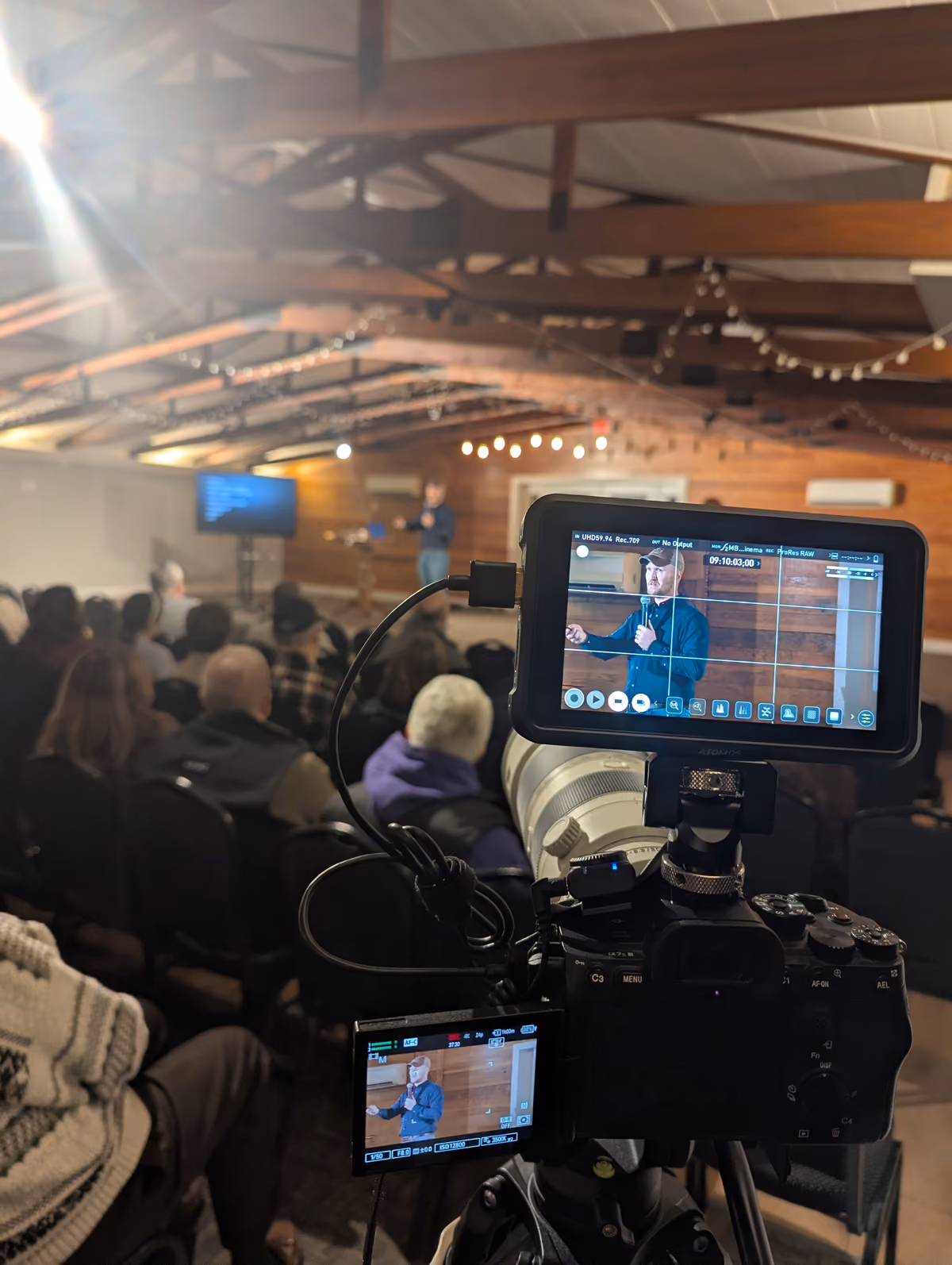 Photo of a talk being recorded on a camera