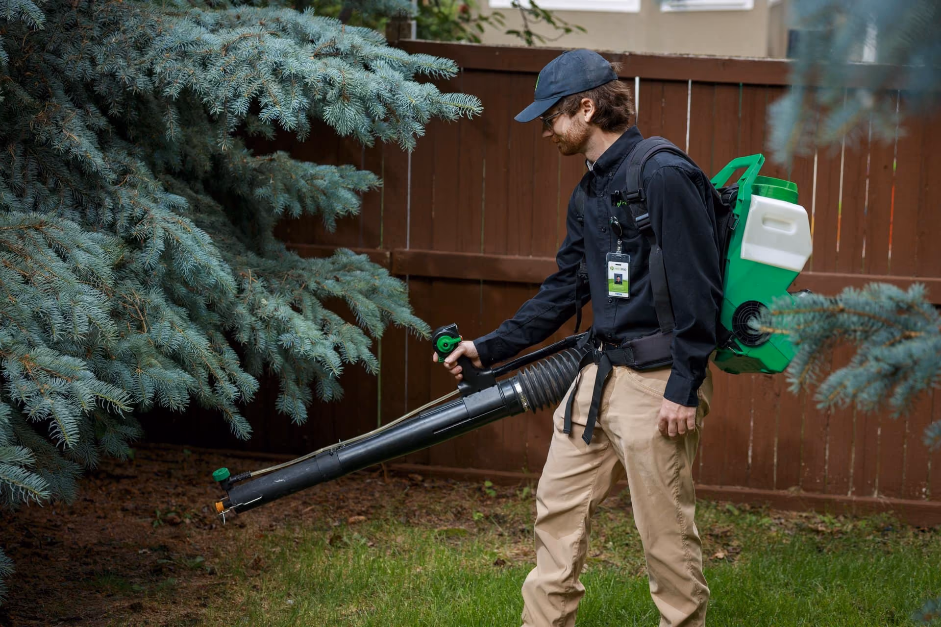 Pest Pro technician using a backpack mister for exterior pest control in Utah
