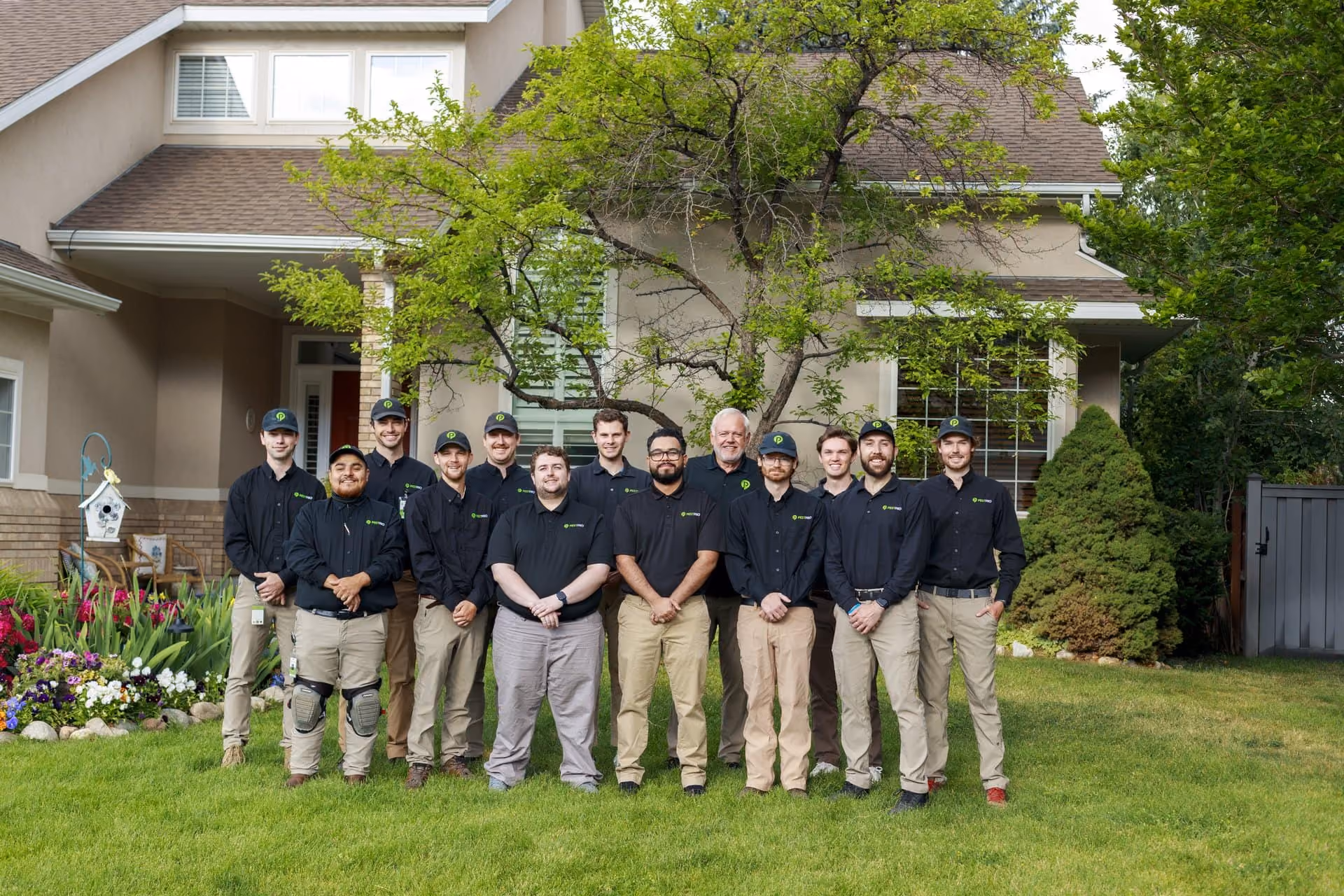 The Pest Pro Pest Control team standing in front of a Utah home