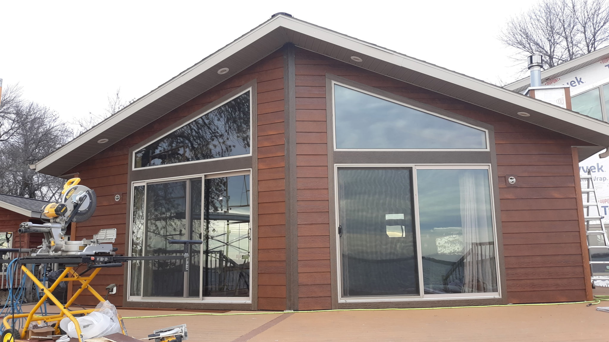 A small yard featuring a quaint house surrounded by a well-maintained lawn.