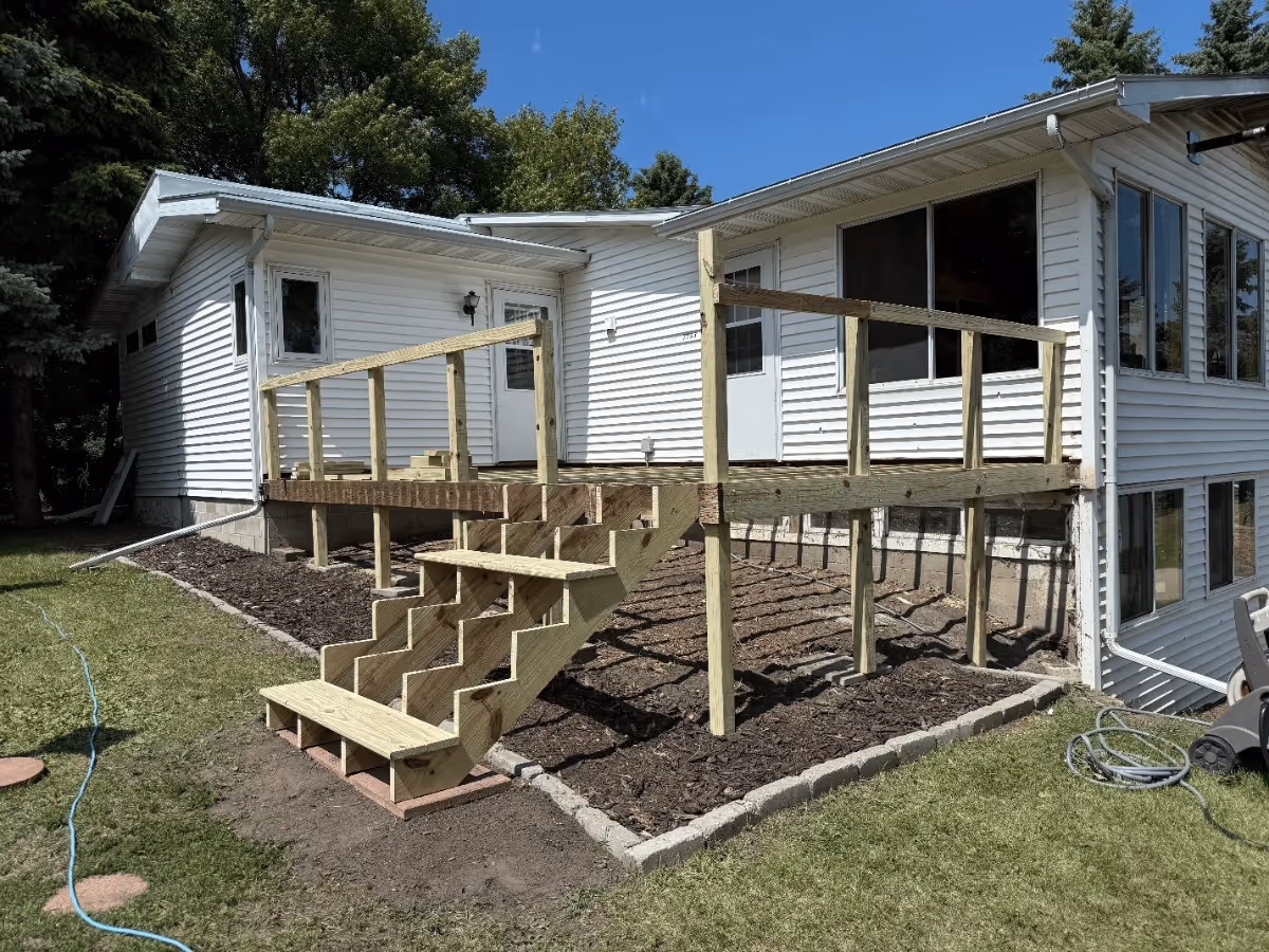 A small yard featuring a quaint house surrounded by a well-maintained lawn.