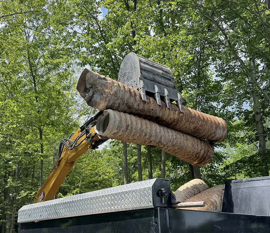Heavy recycling debris being loaded into a Junkit truck during a removal project in Charlotte