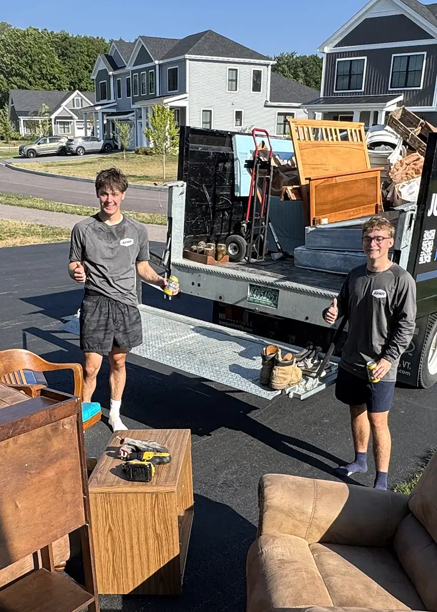 Junkit team removing and loading furniture during a cleanout in Shelburne, Vermont