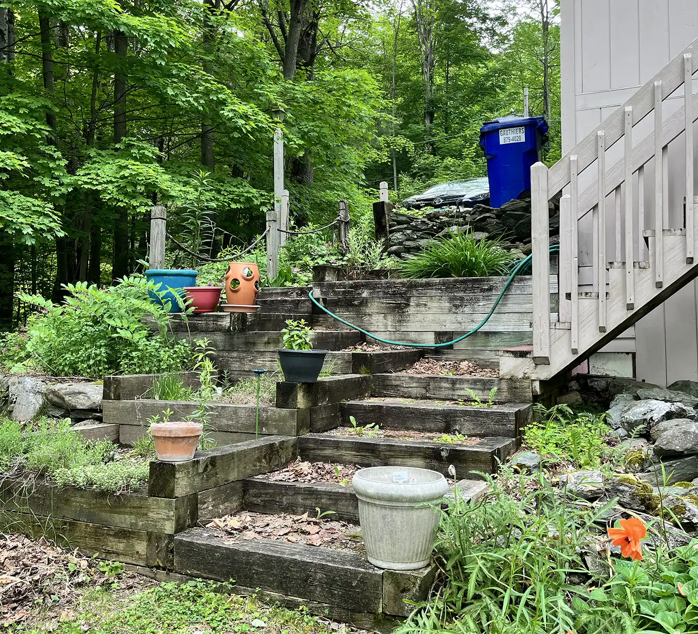 Aging deck and patio area before removal service at residential property in Hinesburg Vermont