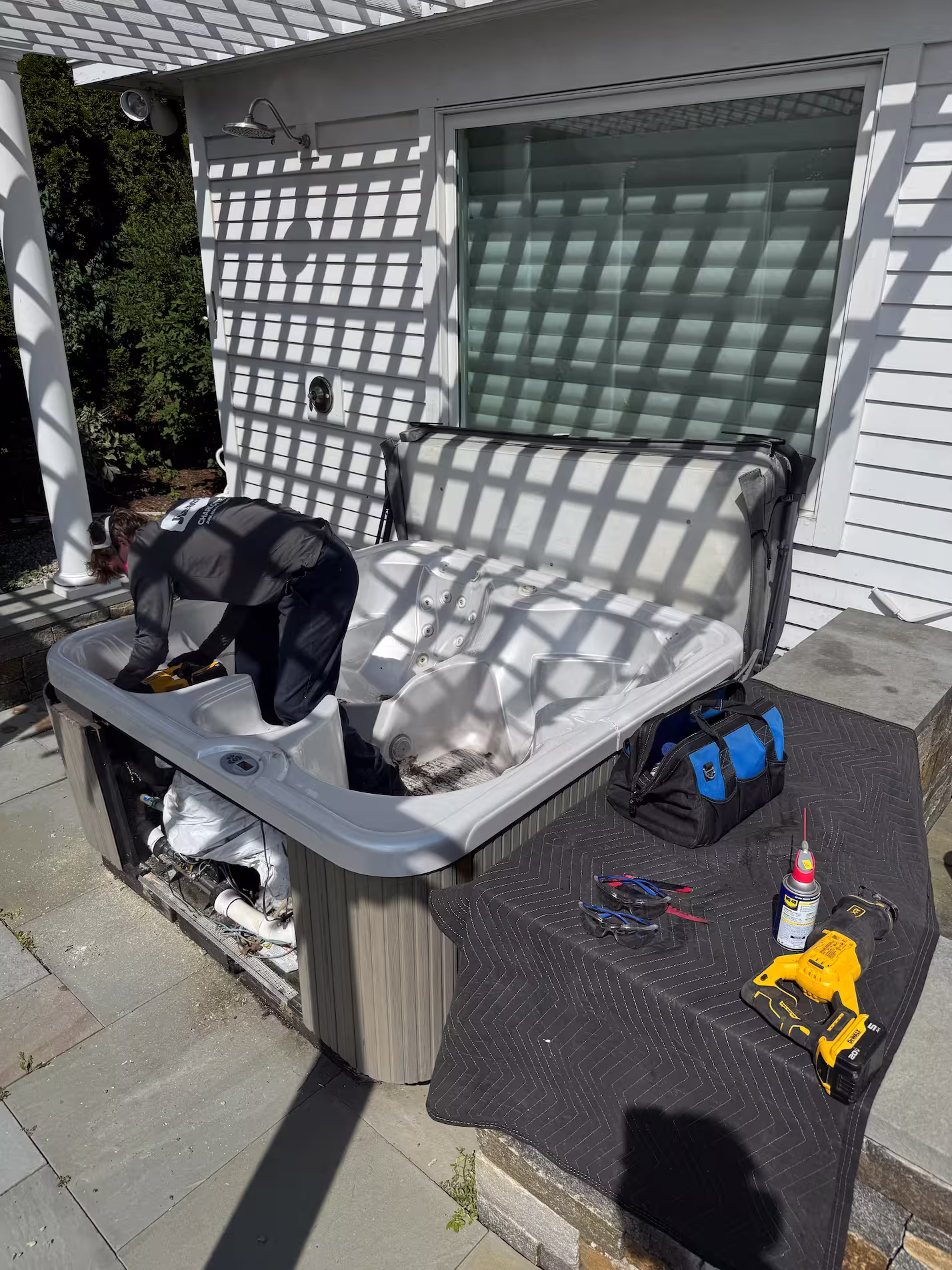 Old outdoor hot tub on deck ready for removal at residential home in Williston Vermont