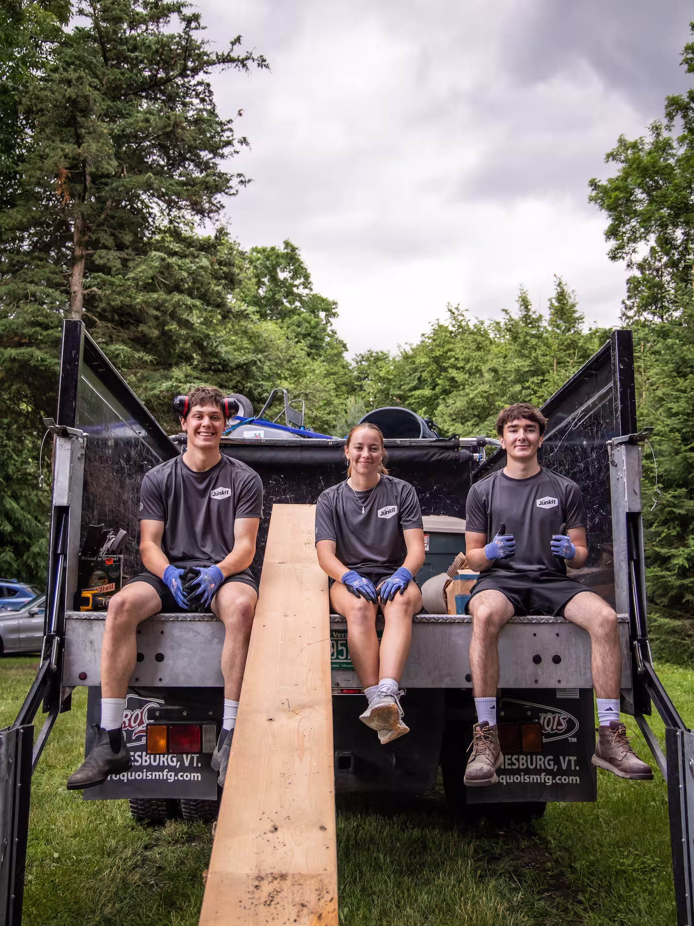 Junkit team members smiling together in front of truck during a removal project