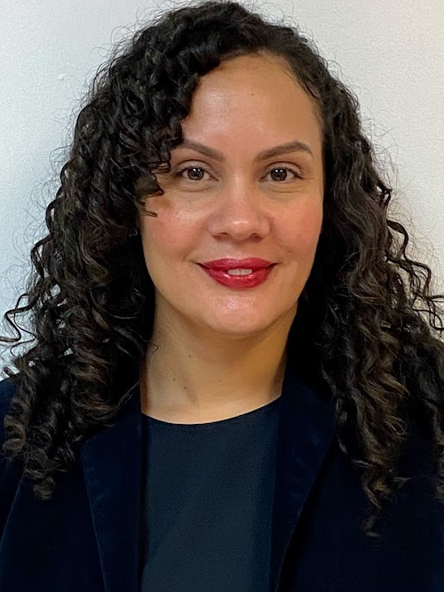 Desiree Sandoval professional headshot smiling in dark blazer