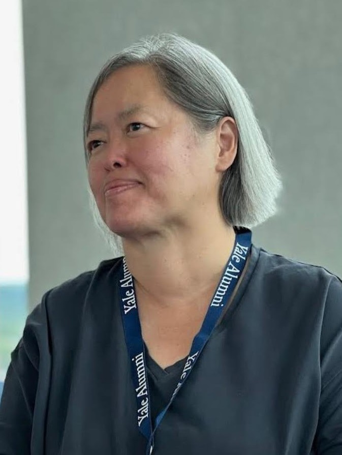 Yuet Chu wearing a Yale Alumni lanyard at an event