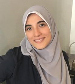 Yousra Abdelhadi smiling in a gray hijab