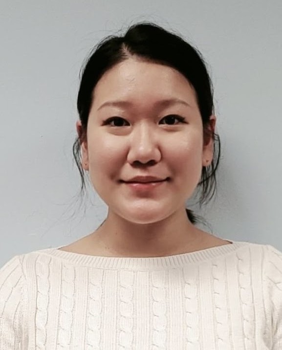 Headshot of Esther No smiling in a white sweater