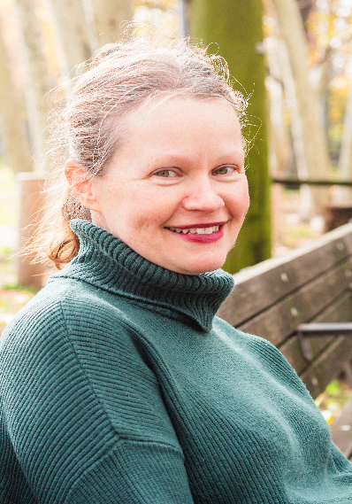 Bernadette Mikolajczyk smiling outdoors in autumn setting