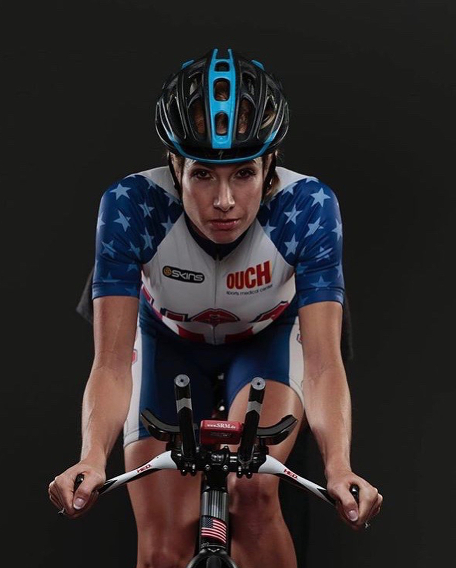 A cyclist in a star-patterned jersey riding a racing bike