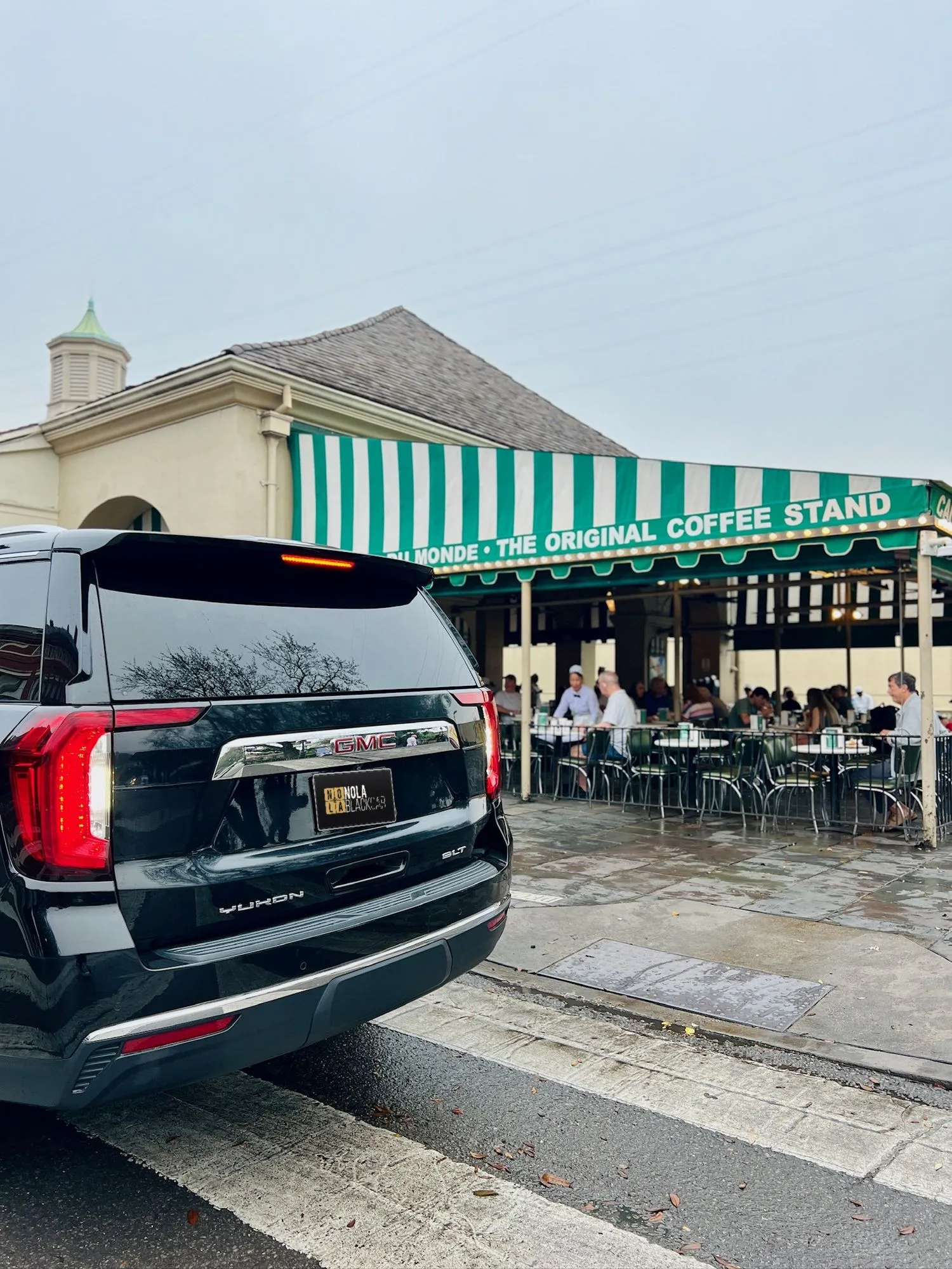 Black SUV outside Cafe Du Monde in the French Quarter
