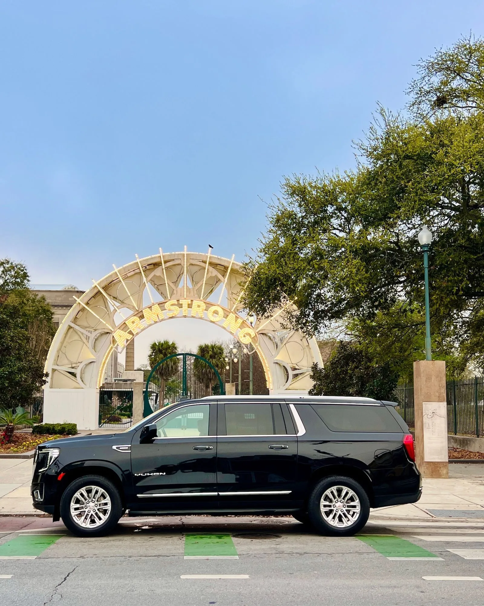 NOLA Black Car SUV at the Louis Armstrong Park entrance arch, New Orleans