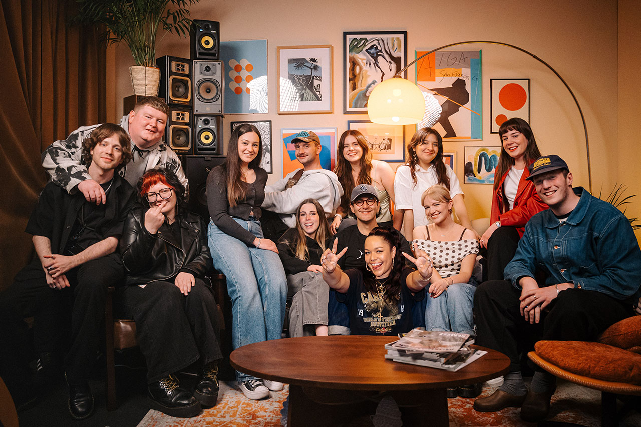 A group of people working in an office, there is a dog