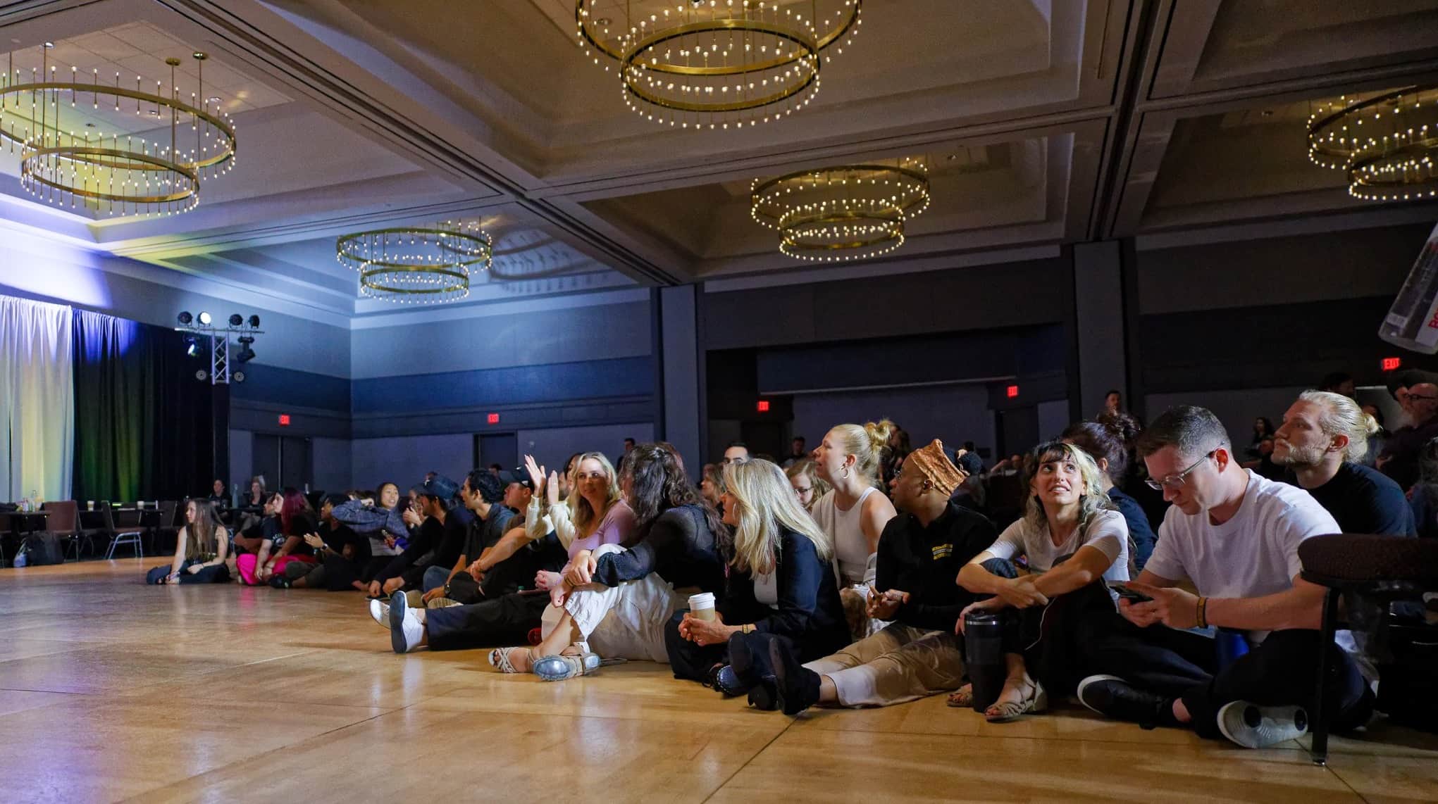 Audience members watching dancers compete 