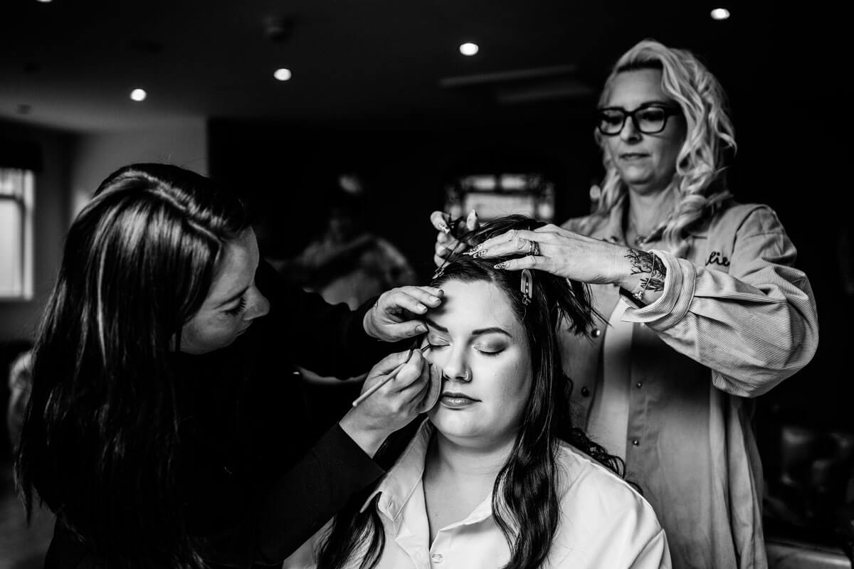 Profile of a woman with blonde hair styled in an updo adorned with delicate decorative pins.