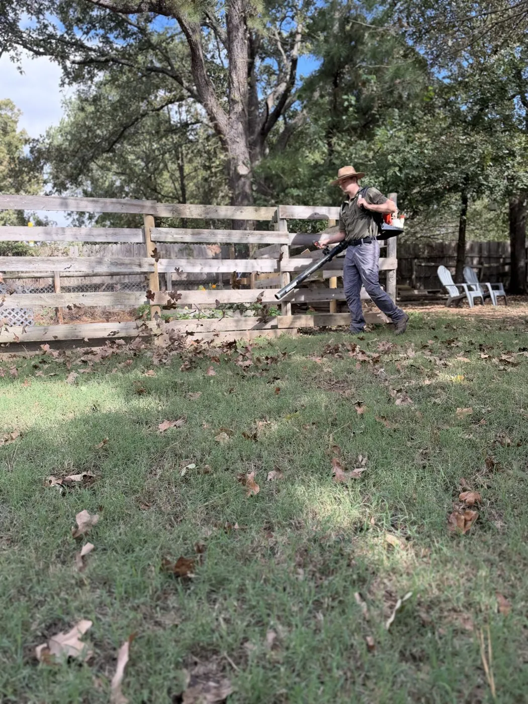 Mason Richardson blowing leaves and debris off a lawn