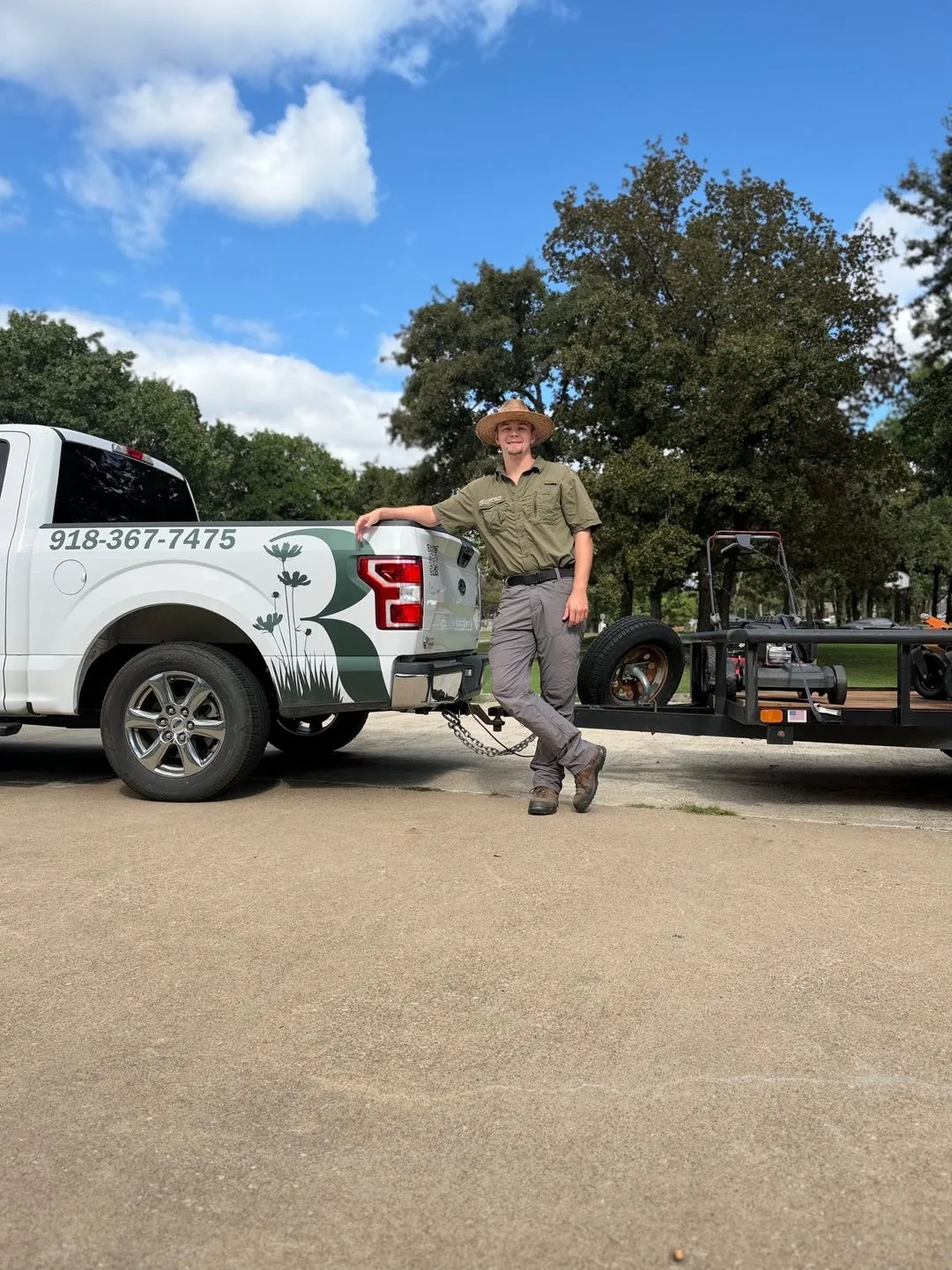 Mason Richardson standing by his Richardson Outdoor Solutions truck and equipment trailer in Sapulpa, Oklahoma