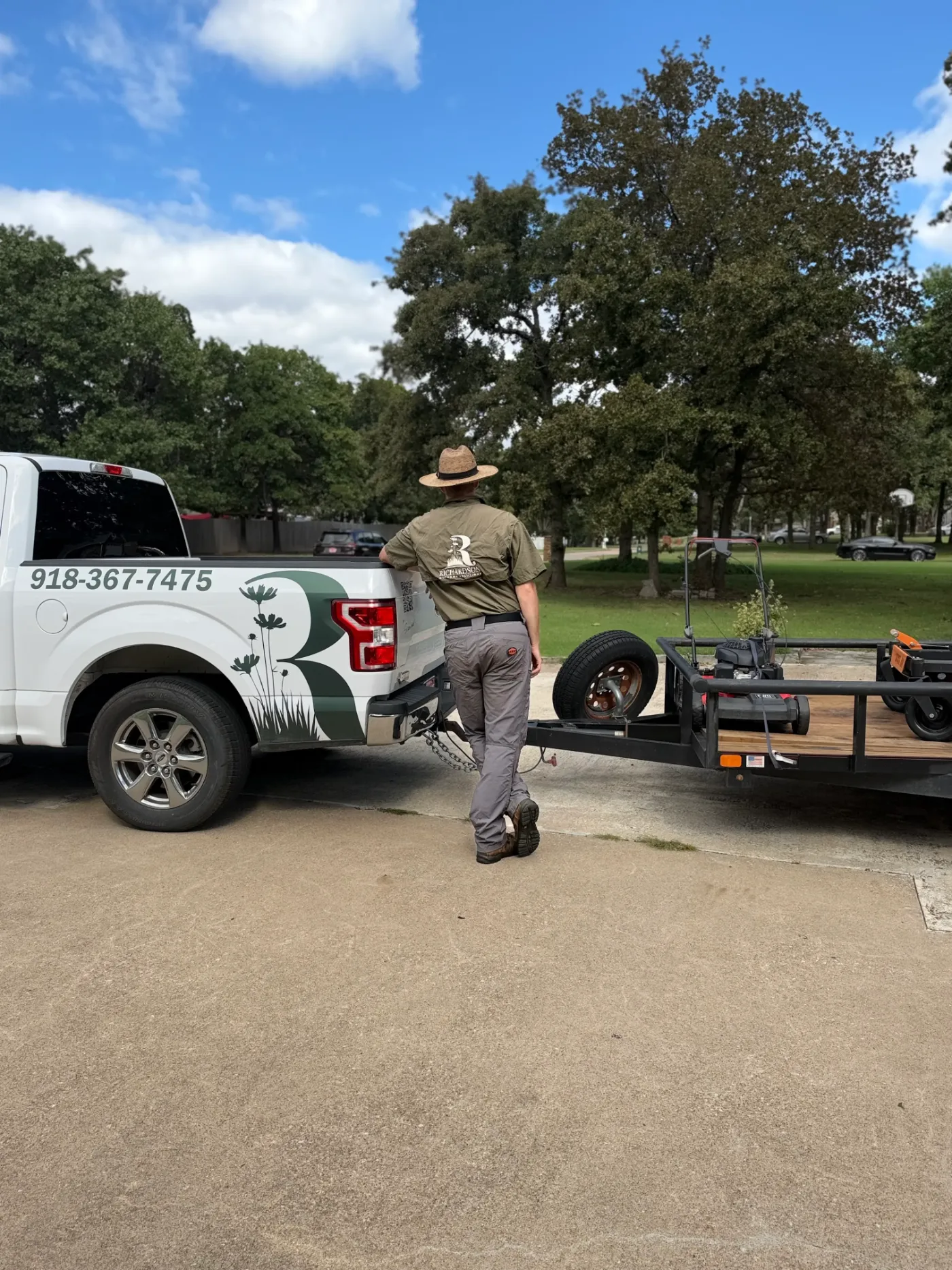 Richardson Outdoor Solutions truck and trailer loaded with lawn equipment