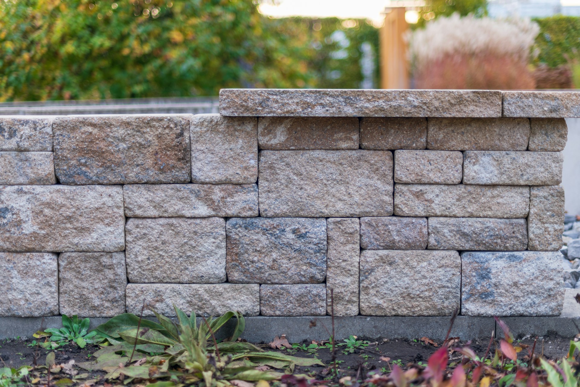 Engineered stone retaining wall in McKinney TX backyard