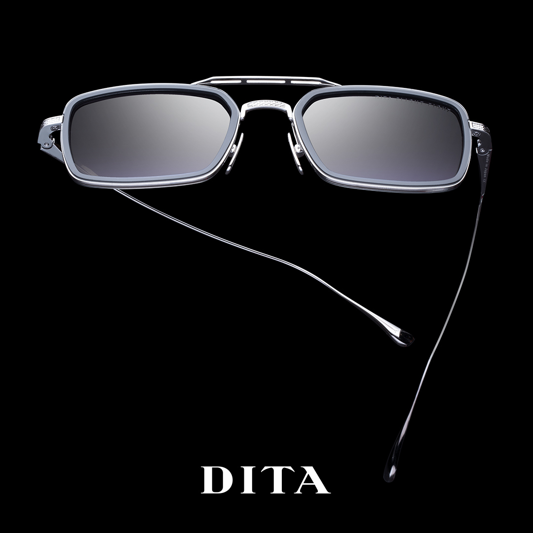 DITA brand sunglasses with rectangular dark lenses and thin metallic temples on a black background.